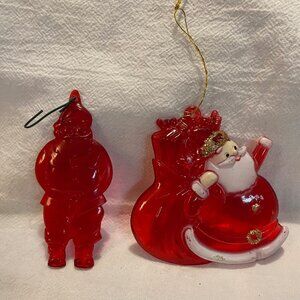 Vintage red hard plastic mid-century Santa ornaments